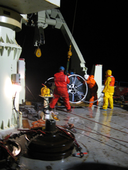 At around 1:00 a.m., EST, an hour or so after the yellow buoyancy sphere went overboard and the mooring deployment officially began, the crew wrestles the first of the two SALP frames into position.