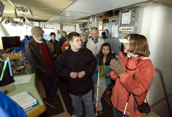Dr. Amy Bower showing students around the Pilot House.
