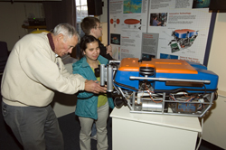 WHOI volunteer Rich Miner with Perkins students at Ocean Science Exhibit Center at Woods Hole Oceanographic Insitution.
