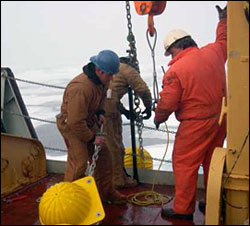 Kris Newhall hauling glass floats to attach to the mooring.