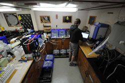 The lab space on R/V KOK has been configured to do many things and to remain safe in heavy weather. This corner is devoted to both processing water samples, which are lashed to the counter and floor, for cesium analysis and to Jarvis CaffreyÃ‚Â’s station radiation monitoring station.