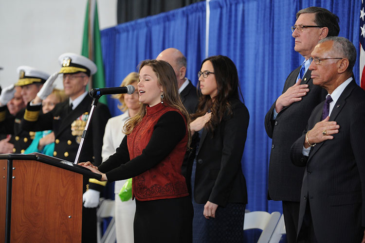 Kali Armstrong, granddaughter of the late astronaut Neil Armstrong, sings the National Anthem during the christening of the Auxilliary General Oceanographic Research (AGOR) research vessel (R/V) Neil Armstrong (AGOR 27).