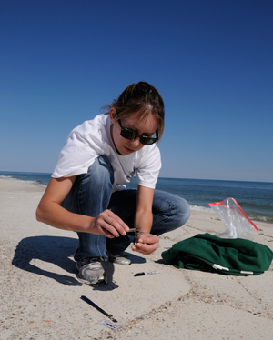 Catherine Carmichael collecting samples on the beach