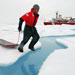 WHOI engineer Kris Newhall jumps across a melt pond