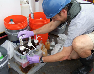 Ben Van Mooy adds reagents to water samples from oil plume