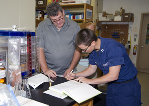 Bob Nelson and Coast Guard officer sign chain-of-custody papers for the sample from Deepwater Horizon