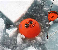 Spherical top float being recovered in the ice.