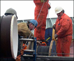 John Kemp and Blaine Blinkhorn spool wire on the winch.