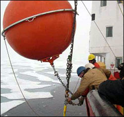 Top flotation sphere being attached at the end of the deployment.