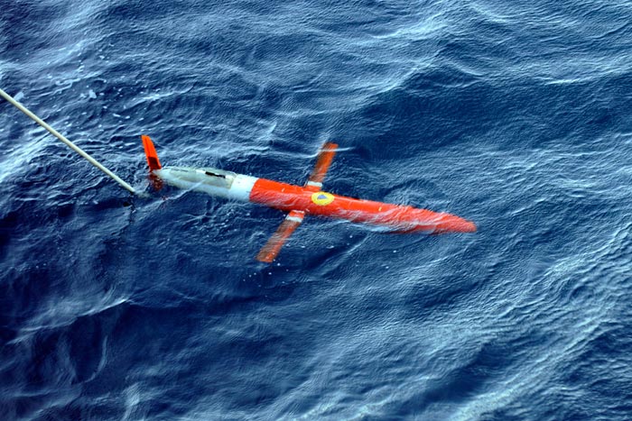 The Spray glider, developed by scientists at WHOI and Scripps, is a 6-foot, 110-pound, torpedo-shaped underwater vehicle that can remain at sea for months. It receives commands from scientists on shore who can direct its movements.