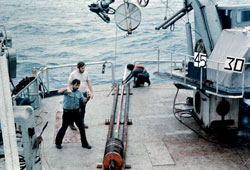 Scientists prepare to lower a heat-flow probe to the seafloor from the fantail of R/V Thomas Washington in 1972. The probe allows scientists to calculate heat flowing through seafloor sediments. (Photo courtesy of Scripps Institution of Oceanography)