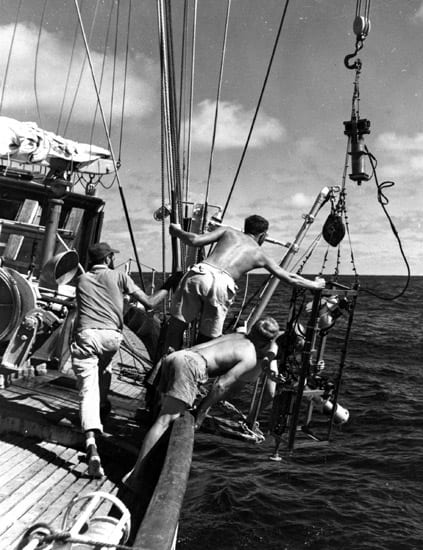 Researchers deploy an instrument from the 142- foot ketch Atlantis, the Institution's first oceangoing research vessel.