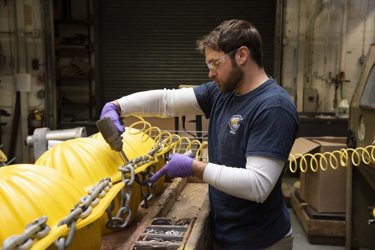 Ryan Laffey prepares glass ball hardhat flotation in the Mooring Lab
