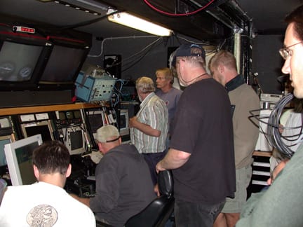 A team of six pilots, engineers and scientists controls Jason from inside the actual control van, a boxcar-sized cargo container crammed full of instrument readouts and video screens. (photo courtesy Dan Fornari, WHOI)