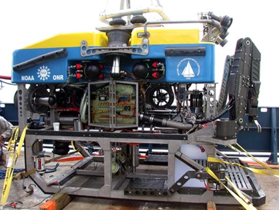 Jason on deck, side panels removed, during sea trials in 2002. At right are one of the two robotic arms and Jason's complement of lights and video cameras. The red fiberoptic tether attaches at left. (photo courtesy Dan Fornari, Woods Hole Oceanographic Institution)