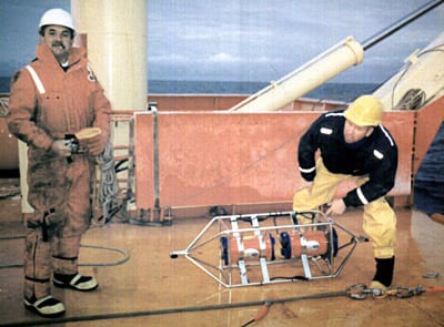 The open ocean is often so deep that the pings from a vessel mounted ADCP won't reach the seafloor. Scott Worrilow (left) and Jimmy Ryder, both of the Woods Hole Oceanographic Institution, lowered this ADCP from the ship on a cable. (Claudia Cenedese