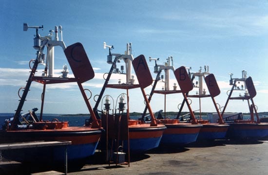 Early tower designs used a tripod shape, like on these FASINEX buoys from the early 1990s. They left little room for instruments and made it hard to get into the buoy well, where the batteries and data processors are stored. (photo courtesy Robert Weller, WHOI)