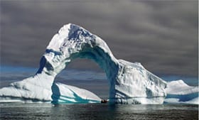 Erosion has carved an icy arch into this Antarctic iceberg found near Booth Island, Lemaire Channel. (Photo by Pat Lohmann, Woods Hole Oceanographic Institution)