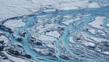 Rivers flow on the ice sheets of Greenland, one of the fastest changing areas of the world due to climate change. (Photo by Sara Das, Woods Hole Oceanographic Institution)