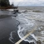 sea washing onto road