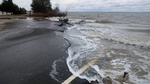sea washing onto road