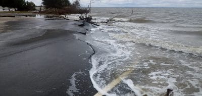 sea washing onto road