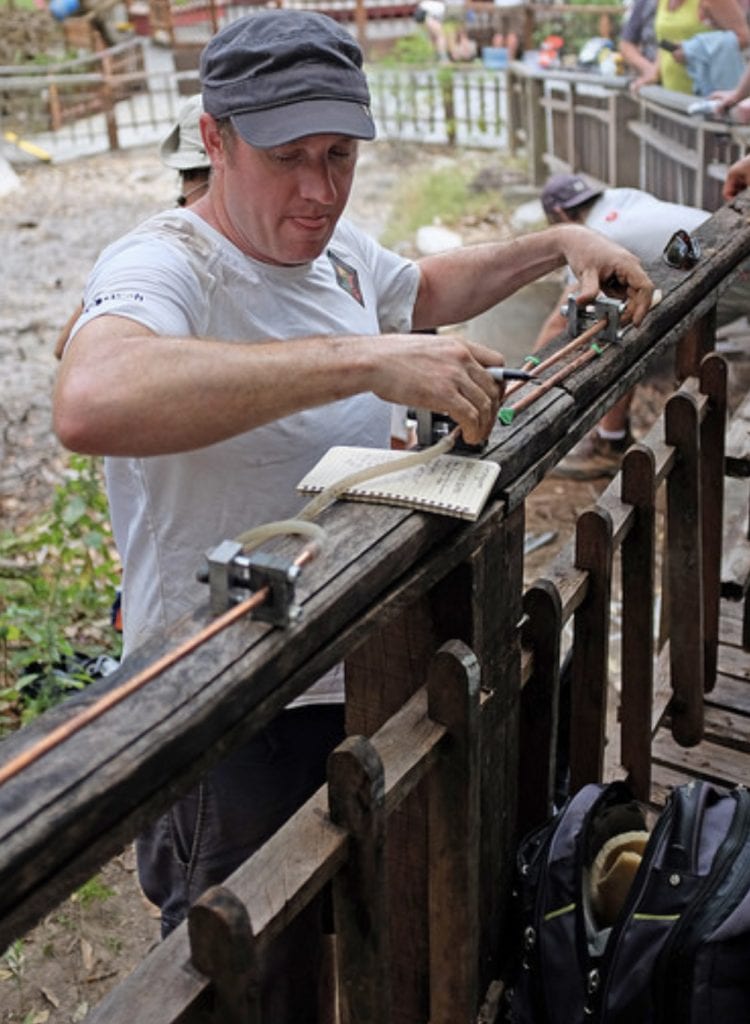 Peter Barry sets up gas sampling equipment at a hot spring in Costa Rica. Credit: Katie Pratt