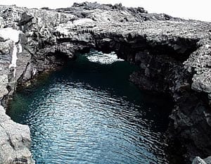Lava tube at the coastline on Santiago Island, Galápagos. Distance across the tube is about 6 meters.