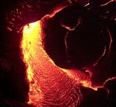 Lava flowing at night during from the Pu’u Oo eruption on Kilauea volcano Hawaii in April, 2000. Scale across photo is about 1 meter.