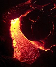 Lava flowing at night during from the Pu’u Oo eruption on Kilauea volcano Hawaii in April, 2000. Scale across photo is about 1 meter.