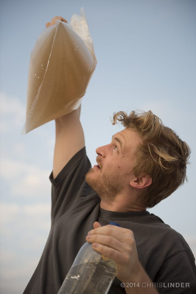 Lead author Jordon Hemingway holding a sample of Amazon river water rich in sediments. Photo by Chris Linder