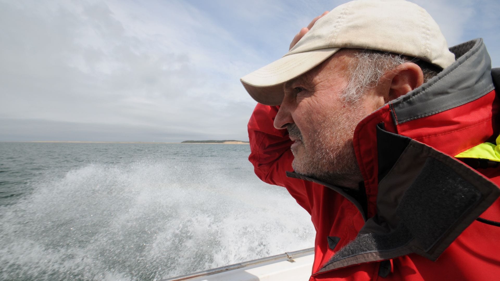 WHOI research specialist Alex Bocconcelli peers out at the ocean off the coast of Cape Cod