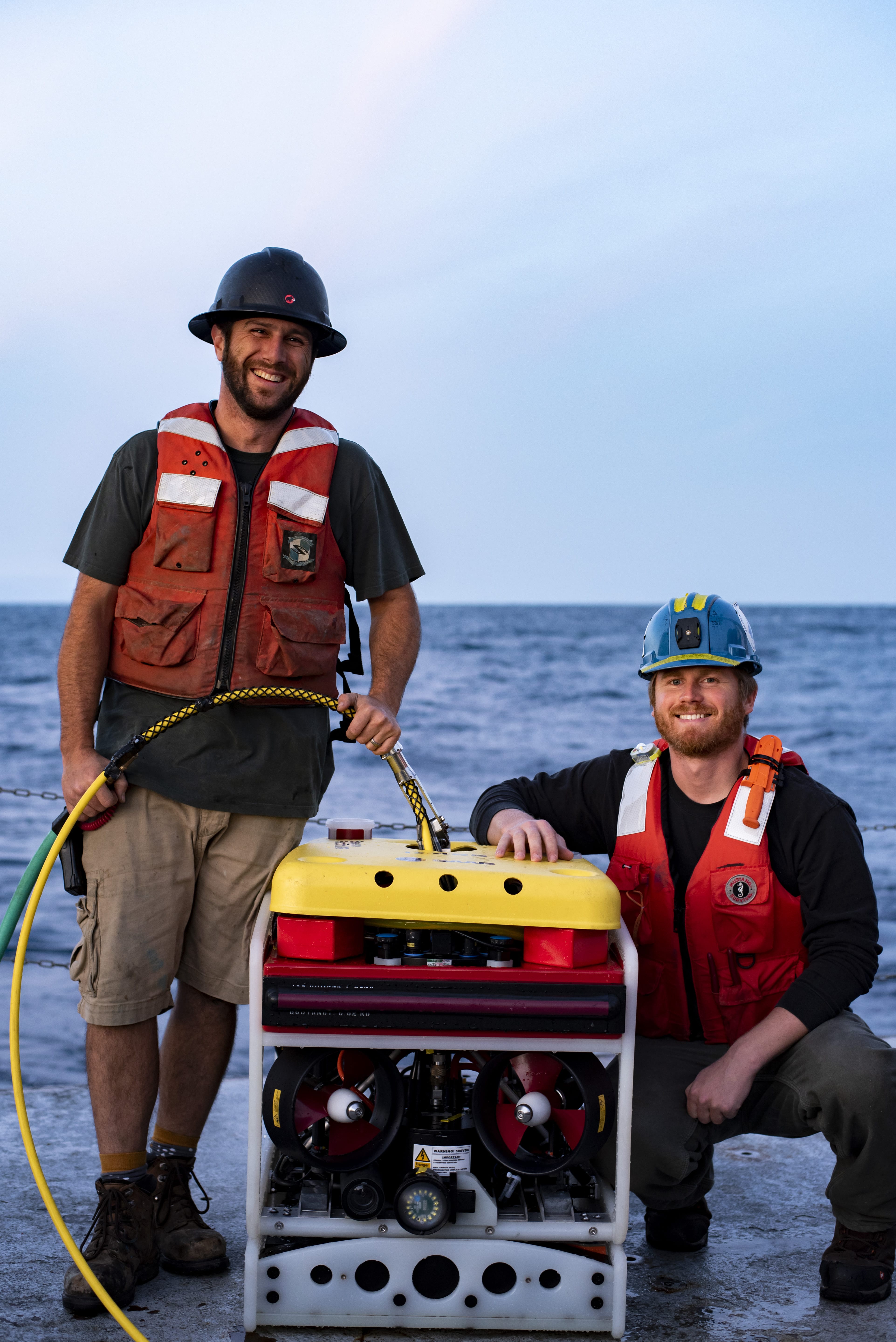 Senior Engineer Jeffrey Pietro (left) and Second Engineer Jared Schwartz (right) pose with the Saab <em>Seaeye Falcon</em> after it successfully located an unrecovered mooring anchor (Photo by Daniel Hentz | Woods Hole Oceanographic Institution)