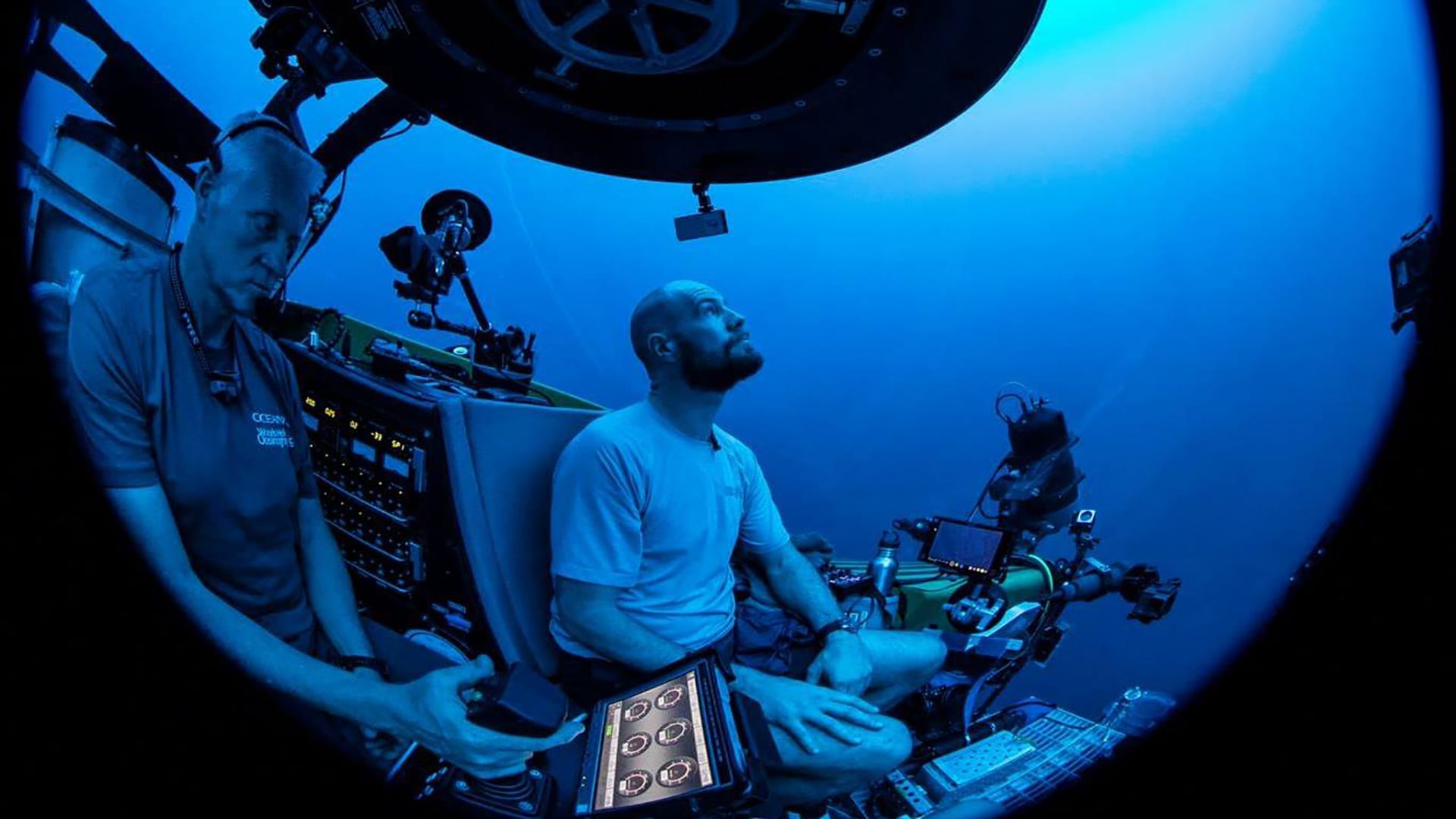 Paul Caiger descends to the ocean twilight zone on the OceanX submersible, <em>Nadir</em>, with pilot Alan Scott at the controls. (Photo by © OceanX Media)