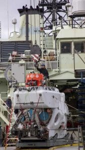 Alvin Pilot and Mechanical Section Leader Danik Forsman securing the crane hook to Alvin while offloading the sub from R/V Atlantis in March.