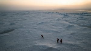 Several intrepid explorers trek out onto the thick Arctic ice sheet to get ice cores that will give them insights into large-scale shifts due to climate change ( Photo by © Luis Lama