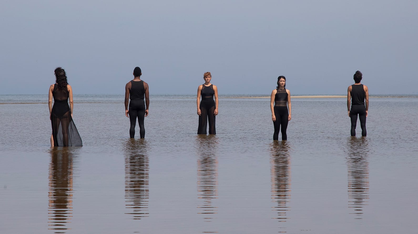 Performers from the Boston Dance Theater pose amid the rising tide along the Cape Cod coastline. (Photo courtesy of Larry Pratt, © Boston Dance Theater)