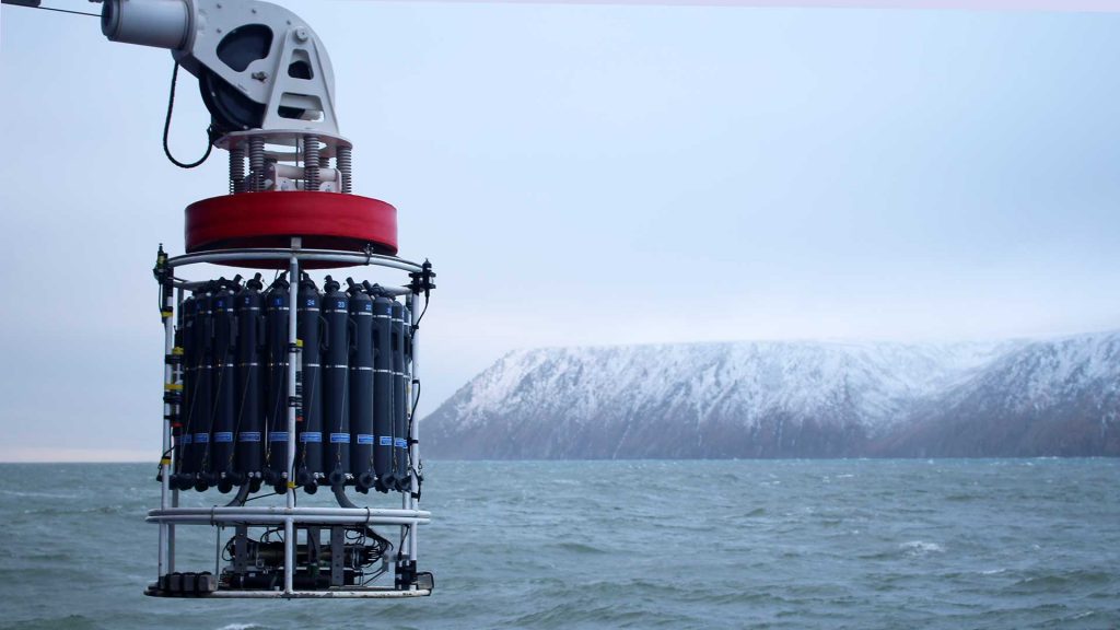 A water sampler known as a conductivity, temperature, depth (CTD) rosette is deployed from the research vessel Sikuliaq during a 2020 expedition as part of the NSF-funded Arctic Observing Network to understand long-term changes in waters of the far north. (Photo ©Woods Hole Oceanographic Institution)