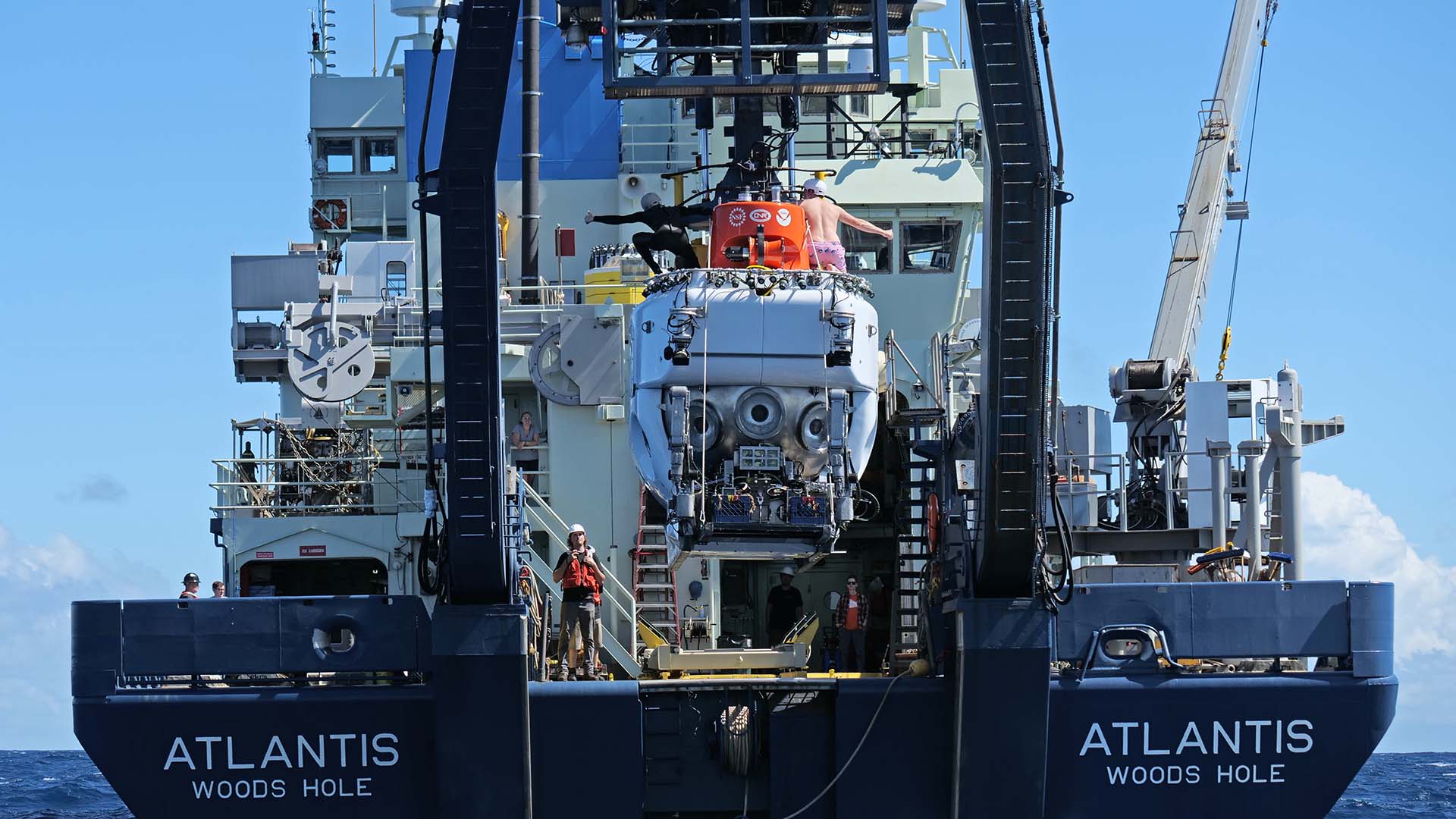 HOV <em>Alvin</em> is deployed off the aft deck of R/V <em>Atlantis</em> during a recent test dive off the coast of San Juan, Puerto Rico. (Ken Kostel, © Woods Hole Oceanographic Institution)