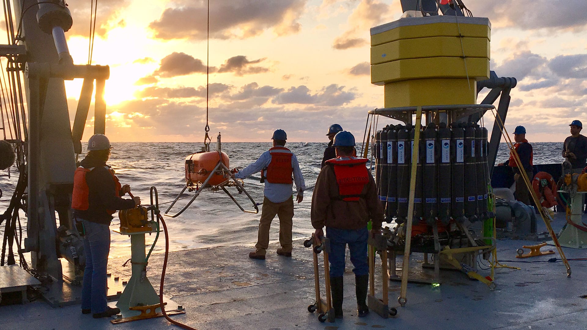 The <i>Neil Armstrong</i> crew begins lowering <i>Orpheus</i> into the Atlantic Ocean for one of the three dives planned for the expedition. (Photo by Emiley Lockhart, Woods Hole Oceanographic Institution)