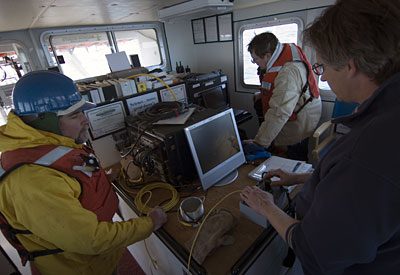 WHOI Engineer Tito Collasius drives the controls on a remotely operated vehicle, panning around with the camera looking for the missing mooring