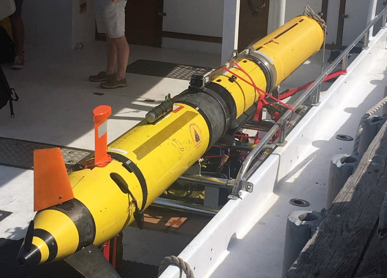 WHOI researchers deployed a REMUS 600 AUV to survey a subsea cable system in Buzzards Bay, Mass. The vehicle uses a propeller and fins for steering and diving, and relies on an internal navigation system to independently survey swaths of the ocean. (Photo by Evan Lubofsky, Woods Hole Oceanographic Institution)