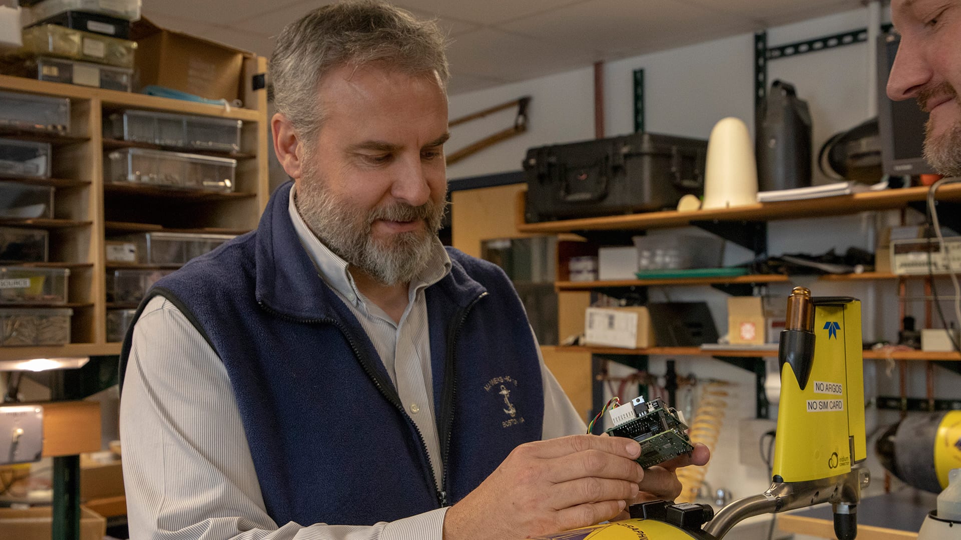 WHOI scientist Rich Camilli holds the “brains” of the under-ice glider—a low-power microcomputer which provides enough processing power to interpret the glider’s sensor data onboard and run adaptive mission plans that help it safely navigate its environment.