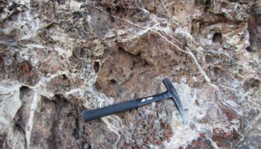 Outcrop of carbonate-altered mantle rock in the San Andreas Fault area. A recent study shows that carbon sequestration in mantle rocks may prevent large earthquakes in parts of the San Andreas Fault. (Photo by Frieder Klein, © Woods Hole Oceanographic Institution)