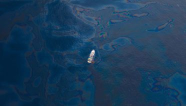 A ship floats in the the Gulf of Mexico after the BP Deepwater Horizon oil spill. (Photo by Kris Krug, Wikimedia Commons)