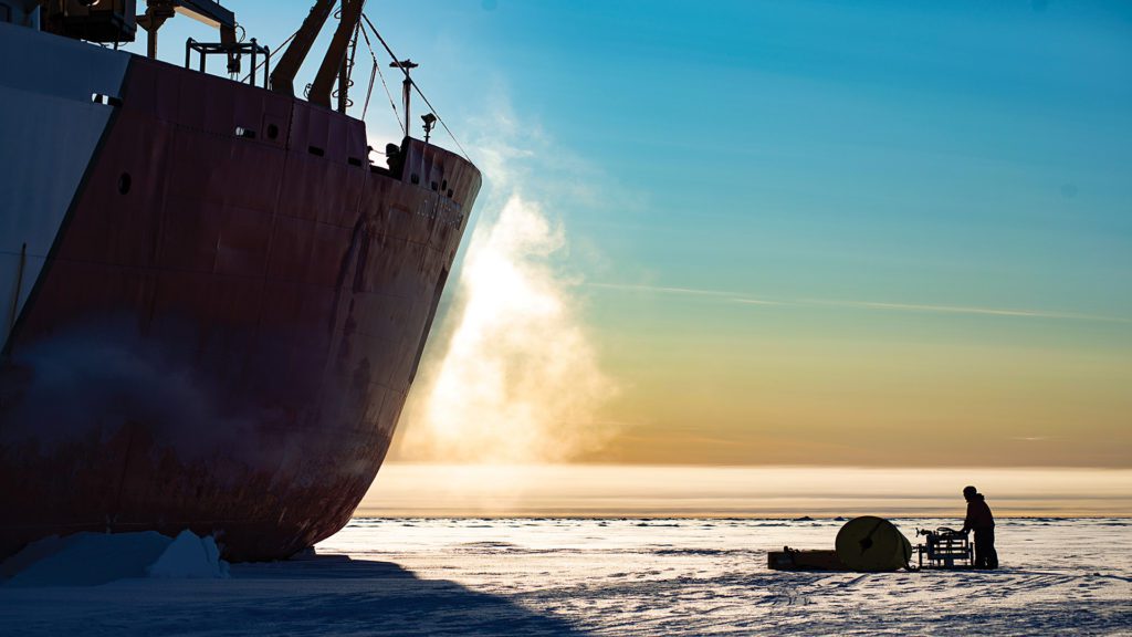 WHOI senior engineer Jeff O’Brien offloads an Ice tethered Profiler buoy and winch from the CCGS Louis S. St-Laurent, a Canadian Coast Guard icebreaker during the 2019 expedition of WHOI’s Beaufort Gyre Exploration Project. (Photo by Fred Marin, © Woods Hole Oceanographic Institution)
