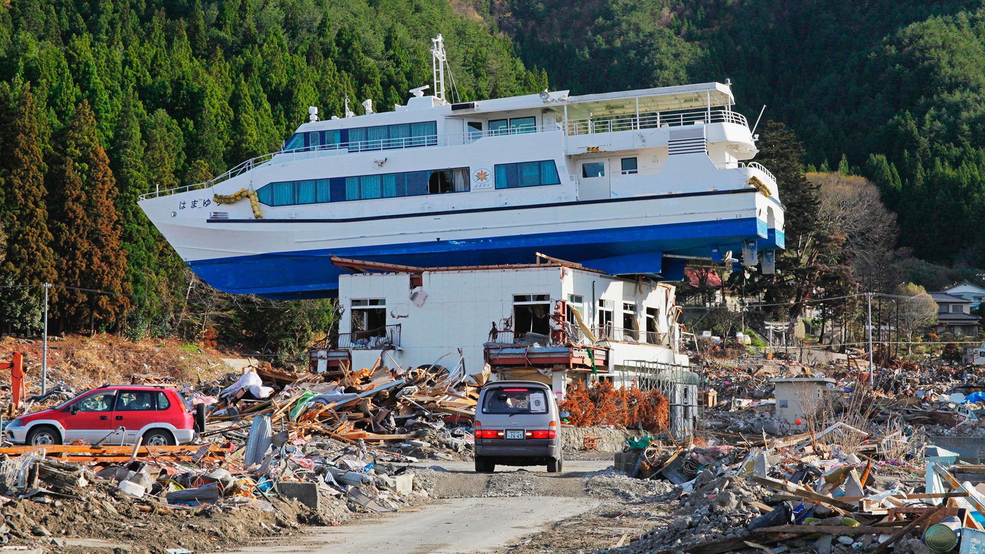 A sight-seeing vessel is seen atop a building in Otsuchi, Japan after being heaved ashore by the Tōhoku Tsunami in 2011.