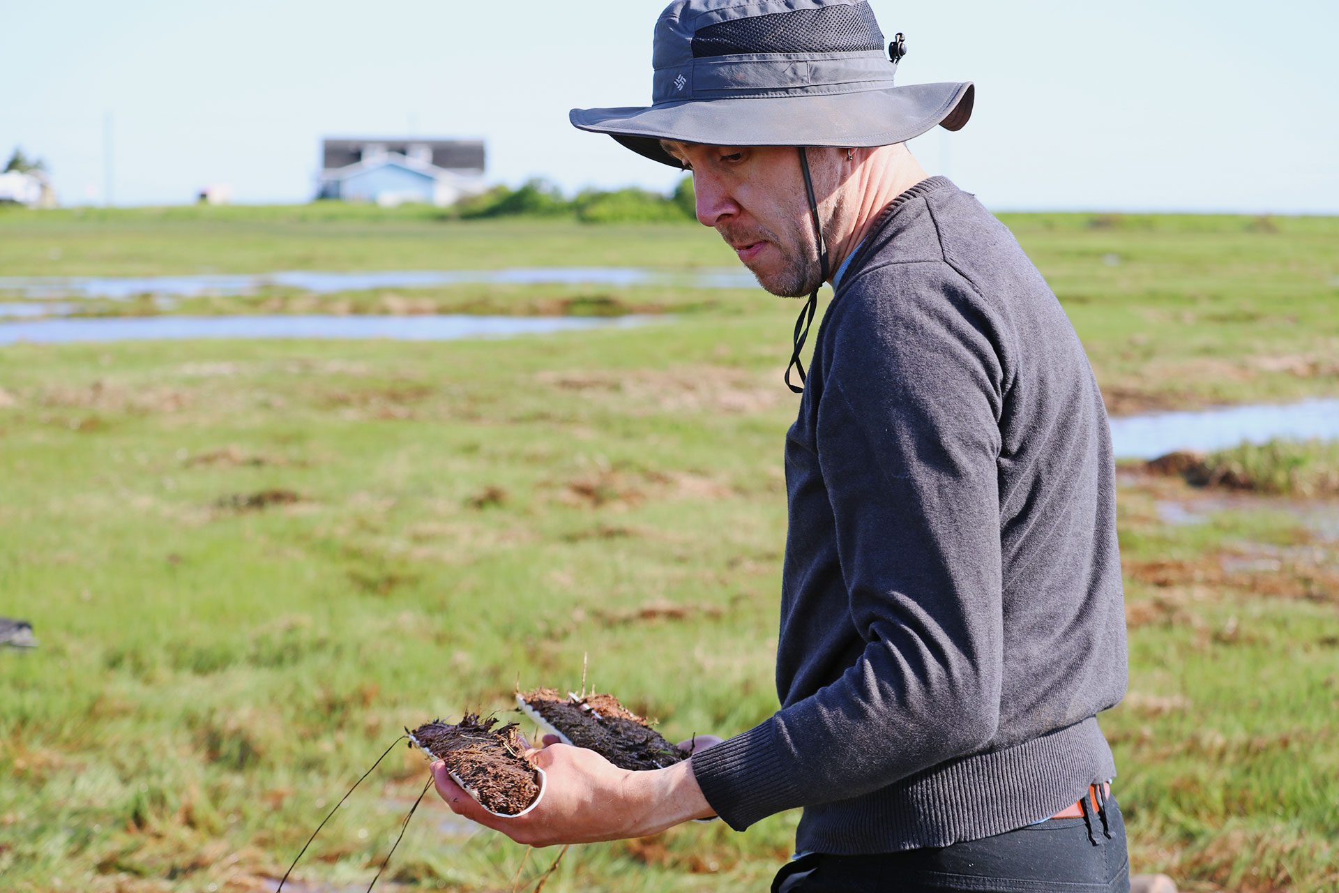 Person carry salt marsh core samples