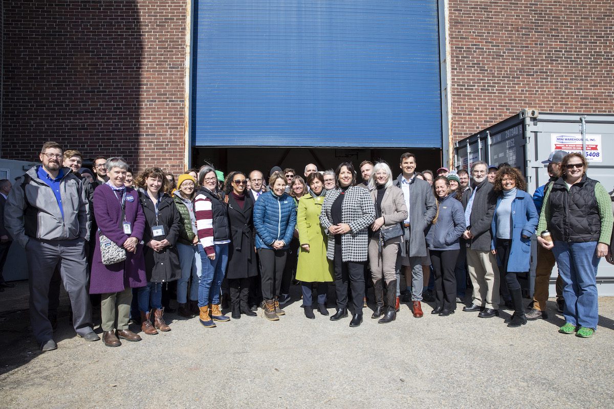 A group of WHOI staff and regional leaders pose for a photo outside the Iselin high bay following remarks from Gov. Healey, Lt. Gov. Kim Driscoll, Sec. Tepper, and state representatives. (Photo by Jayne Doucette
© Woods Hole Oceanographic Institution)