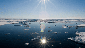 Arctic sunburst reflects across the water